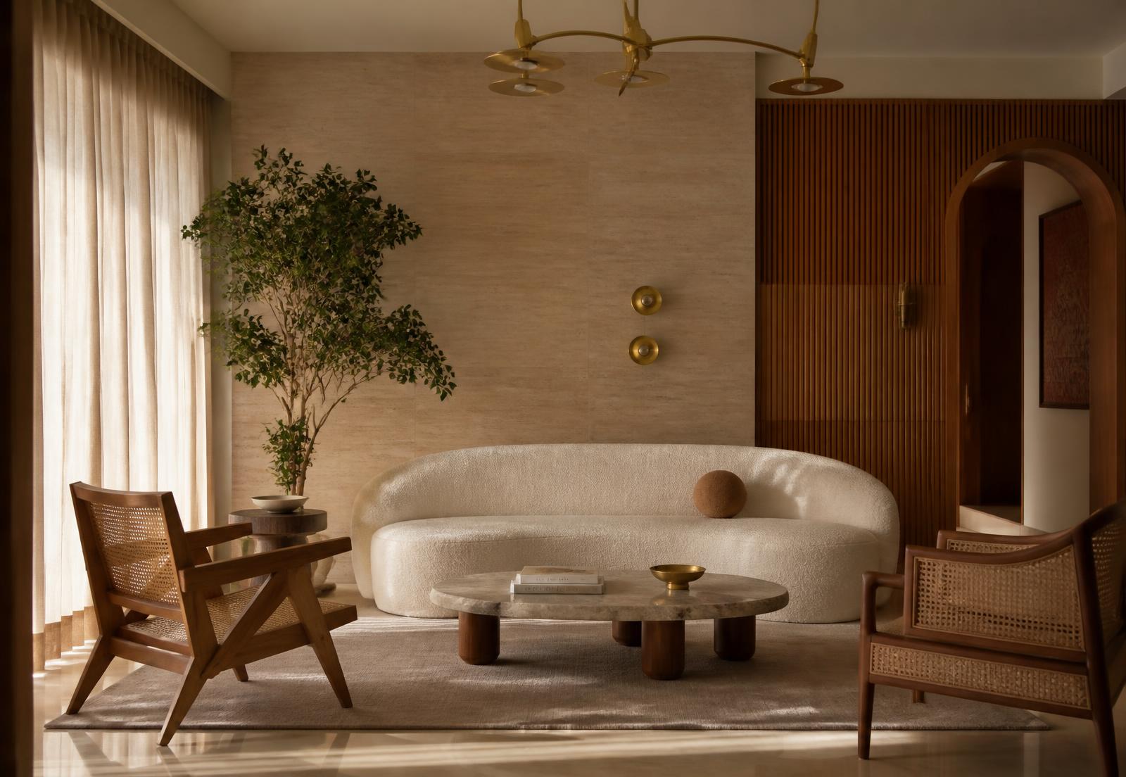 Warm minimal living room with travertine wall, fluted teak paneling and a cream curved sofa